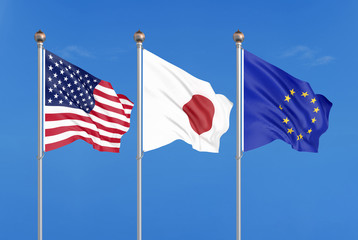 Three colored silky flags in the wind: USA (United States of America), EU (European Union) and Japan. 3D illustration.