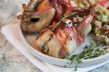 delicious baked quail with bacon and side dish