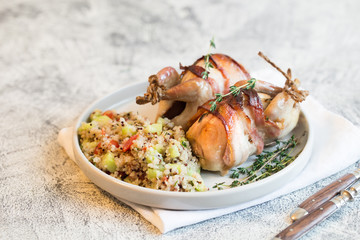 delicious baked quail with bacon and side dish