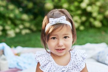 baby girl on a picnic in the summer garden