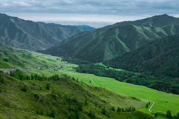 Fototapeta premium high green mountains and dark clouds