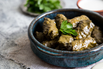 Traditional dolma  (sarma) in grape leaves with copyspace. Lebanon turkish greek middle eastern cuisine. Dinner food dolmadakia
