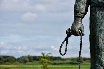 Hand of a skipper of a ferry holding rope