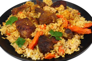 pilaf with meat on black plate isolated on white background