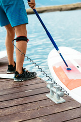 Board for sap surfing tied to the leg of a man