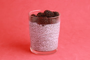 glass of chia pudding with blackberry flavor