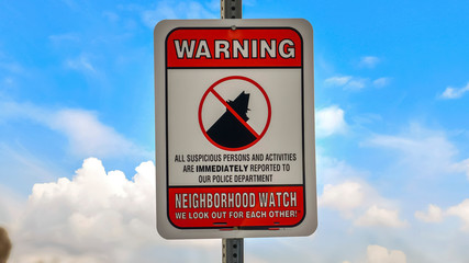 Panorama Close up of a Warning sign on a neighborhood against cloudy blue sky background