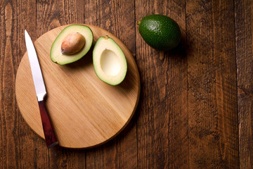 Beautifully plated avocado toast with delicious-looking toppings on wooden brouw background. Making...