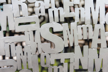 silver metallic letters in chaotic order