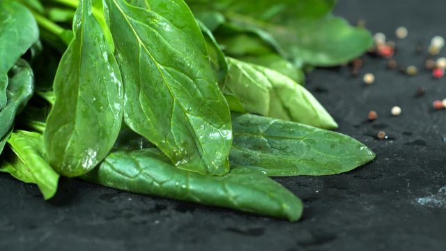 Green spinach slowly falls on the table Slow Motion