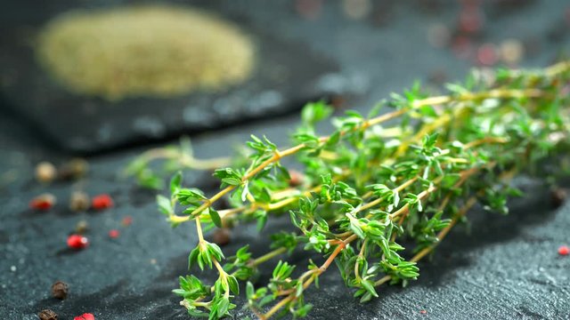 Green thyme slowly falls on the table