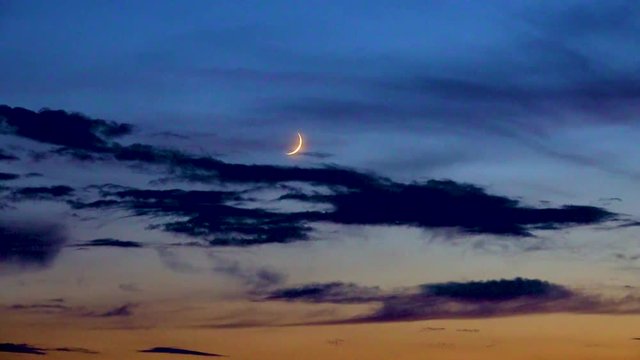 new moon in the background of clouds