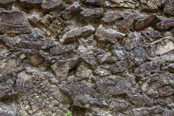 Old cracked stone masonry wall texture