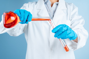 Young scientist with test tube making research in clinical laboratory.Professional science specialist at work.