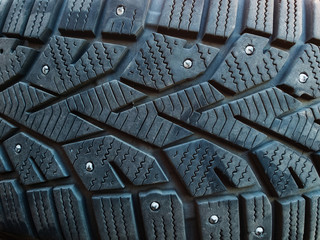 Close-up of winter studded car tyre protector