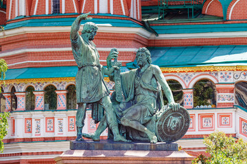Fototapeta na wymiar Monument to Minin and Pozharsky on Red square in Moscow closeup against walls of Saint Basil Cathedral in sunny summer day