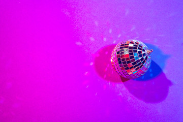 Shiny small disco balls sparkling in a beautiful purple light. Disco party concept