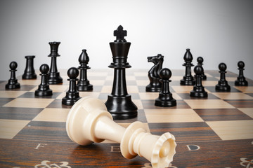 One chess pieces staying against thel set of chess pieces. Strategy, business concept
