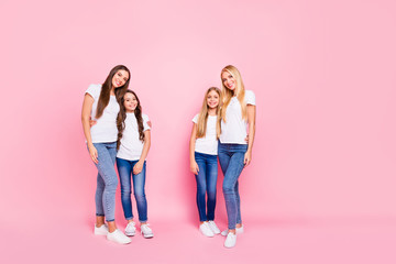 Naklejka premium Full body photo of four different age ladies hugging wear casual outfit isolated pink background
