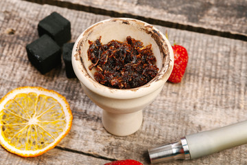 Parts of hookah and fruits on wooden background