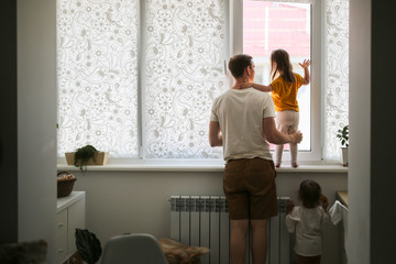 dad and daughters near the window, alone dad