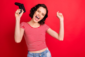 Portrait of her she nice attractive pretty cheerful cheery glad wavy-haired girl having fun spending free spare time holiday weekend isolated over bright vivid shine red background © deagreez
