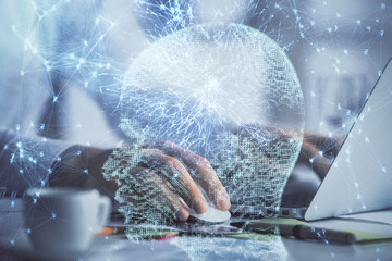 Man typing on keyboard background with brain hologram. Concept of big Data.