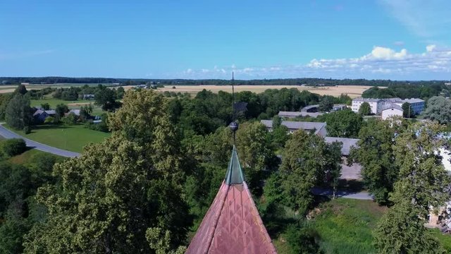 Aerial Dron Shot of the Cirava Lutheran Church Aizpute  Latvia, Sunny Summer Day. Flaying Above the  Church and Manor Castle.
