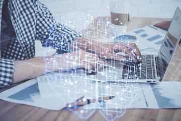 Man typing on keyboard background with brain hologram. Concept of big Data. Double exposure.