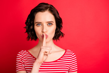 Photo of gorgeous girl showing you sign to stop talking while isolated with red background