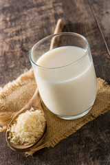 Rice milk in glass on wooden table.