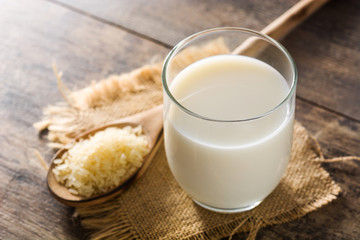 Rice milk in glass on wooden table.