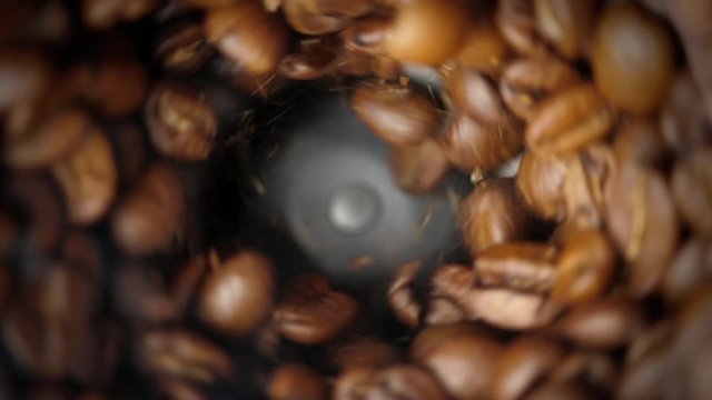Electric coffee grinder works. Slow motion. High angle view.