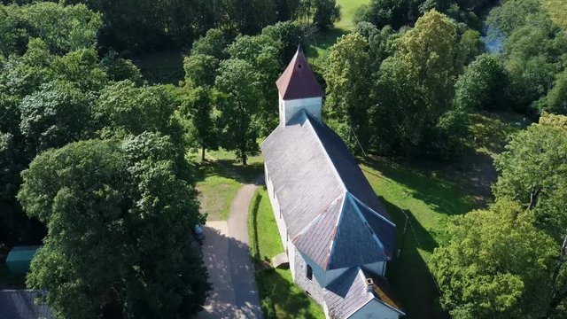 Aerial Dron Shot of the Cirava Lutheran Church Aizpute  Latvia, Sunny Summer Day. Flaying Above the  Church and Manor Castle.