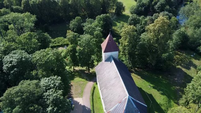 Aerial Dron Shot of the Cirava Lutheran Church Aizpute  Latvia, Sunny Summer Day. Flaying Above the  Church and Manor Castle.