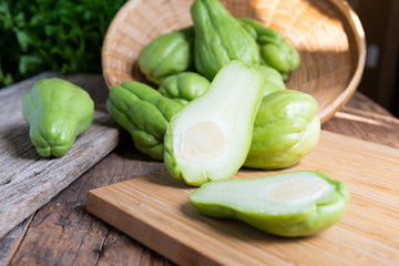 Fresh chayote fruits (Sechium edulis) on wood background
