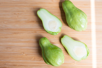 Fresh chayote fruits (Sechium edulis) on wood background