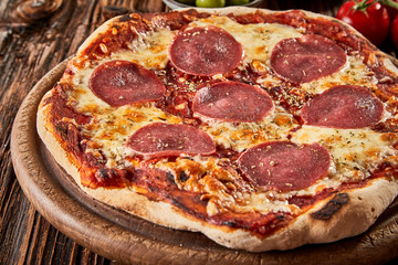 Tasty flame-grilled Italian salami pizza