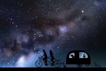 Newlyweds on bike tandem on road at night. Vector illustration with silhouettes of people and dog traveling with camper trailer. Family road trip. Space dark background with starry sky and Milky Way