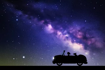 Foto op Canvas Cartoon retro car on road at night. Vector illustration with silhouettes of woman and dog traveling in camper. Family road trip. Space dark background with starry sky and Milky Way © arvitalya