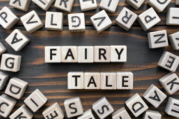 fairy tale - word from wooden blocks with letters, Literary Genres concept, random letters around,...