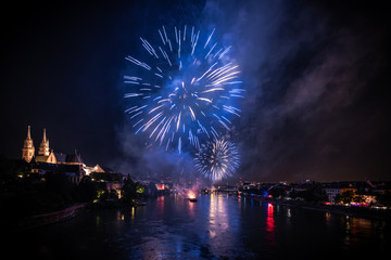 1. August celebration with fireworks in Basel, view from Wettsteinbrücke to the Münster
