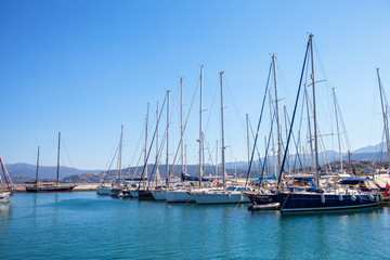 Fototapeta na wymiar Beautiful yachts in the port of Agios Nikolaos, Mirabello Bay, Crete, Greece