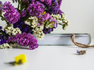 A bouquet of dried flowers and a notebook. The planning of the event. Bookmark the notebook