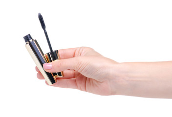 Black mascara in gold tube in hand beauty on white background isolation
