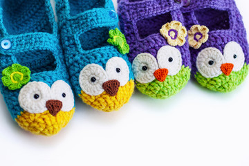  Women's hobby. Crochet and knitting. Working space. Cozy colorful Slippers in the form of owls for the home. Vertical