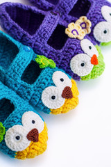  Women's hobby. Crochet and knitting. Working space. Cozy colorful Slippers in the form of owls for the home. Vertical