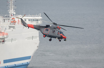 HELICOPTER AND SHIP - A sea Search And Rescue helicopter of the Polish Coast Guard in action by the...