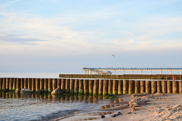 Baltic sea beach with views of breakwaters and pier