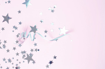 The background is pink with lots of silver stars and curlicues.